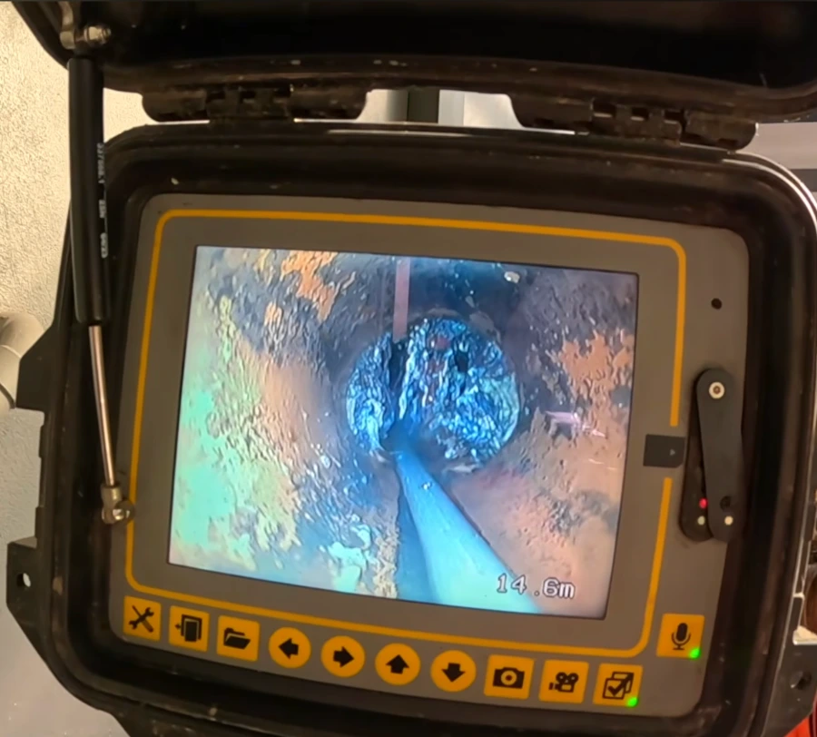Sewer camera inspection monitor showing live pipe footage