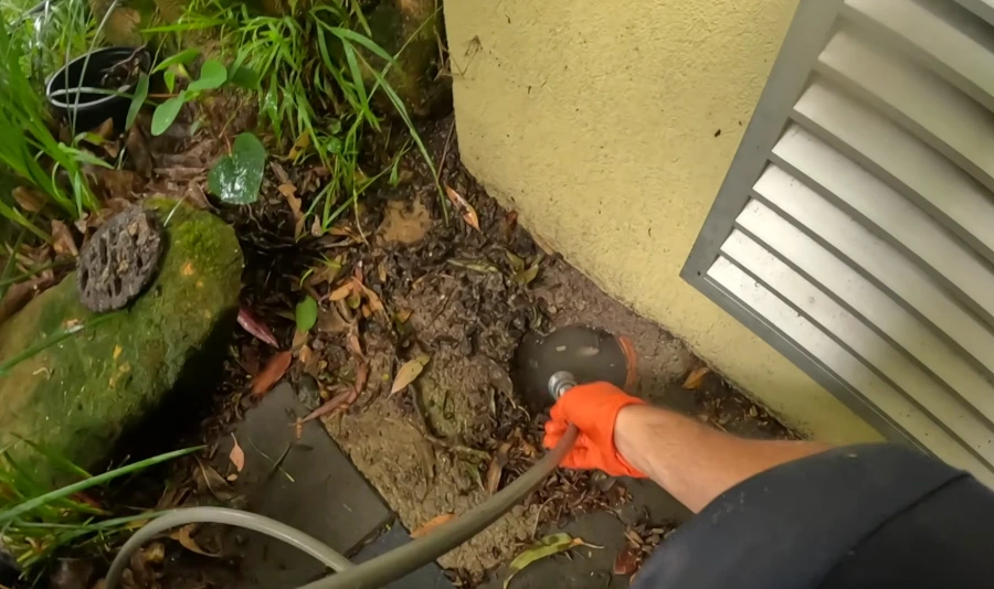 Exterior cleanout access point near a Spokane home foundation